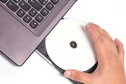 CD being inserted into a Laptop